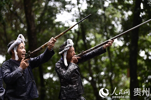 在贵州省从江县丙妹镇岜沙村，村民在给游客表演节目。吴德军 摄