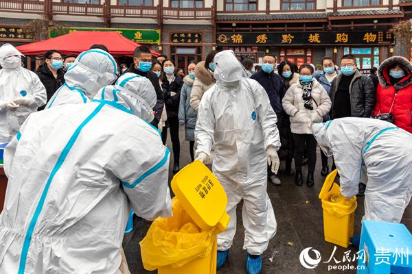 2020年12月14日，貴州省畢節市黔西縣開展疫情防控核酸應急檢測演練，醫務工作人員在收集採集現場的垃圾廢物。