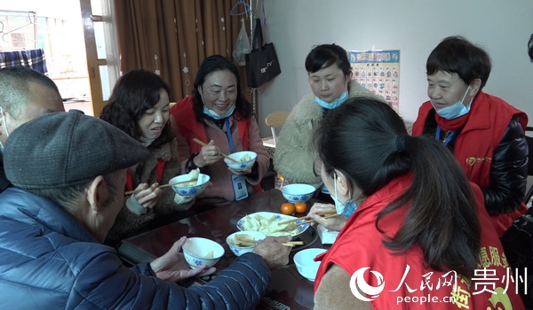 社區黨員干部及志願者和社區老人一同吃餃子過新年。李甜甜 攝