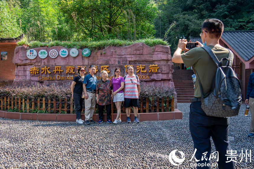 游客在“中国丹霞”赤水世界自然遗产佛光岩景区合影。人民网 涂敏摄