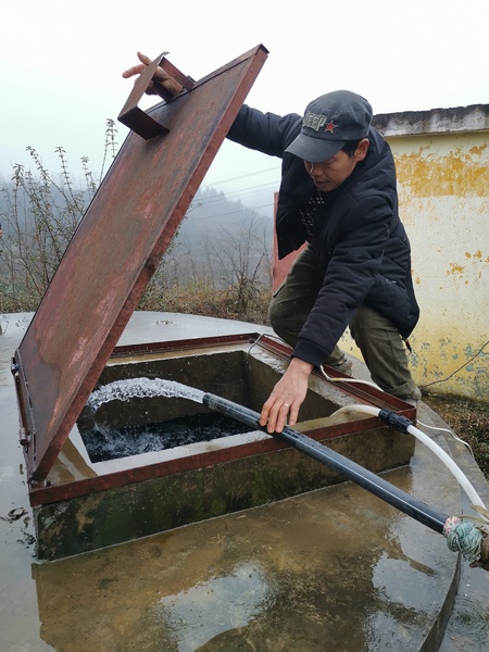 野角鄉白龍村管水員劉修偉在檢查飲水工程水池水量。