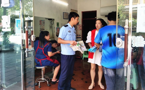 大方县雨冲乡志愿者向社区沿街商铺发放宣传手册。
