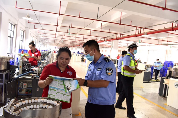 2  圖為民警深入錦屏縣亞獅龍車間發放宣傳資料。劉光榮攝