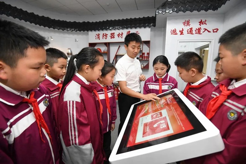 在南明区花果园第三小学消防体验馆，学生们正在老师的指导认识消防标识牌。