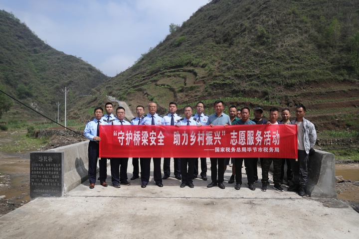 税务人员与当地村干部共同开展“守护桥梁安全助力乡村振兴”志愿服务活动。