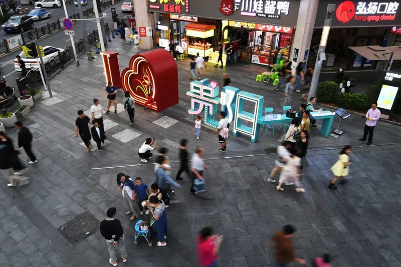 南明区青云路步行街人头攒动，不少市民游客前来消费打卡。