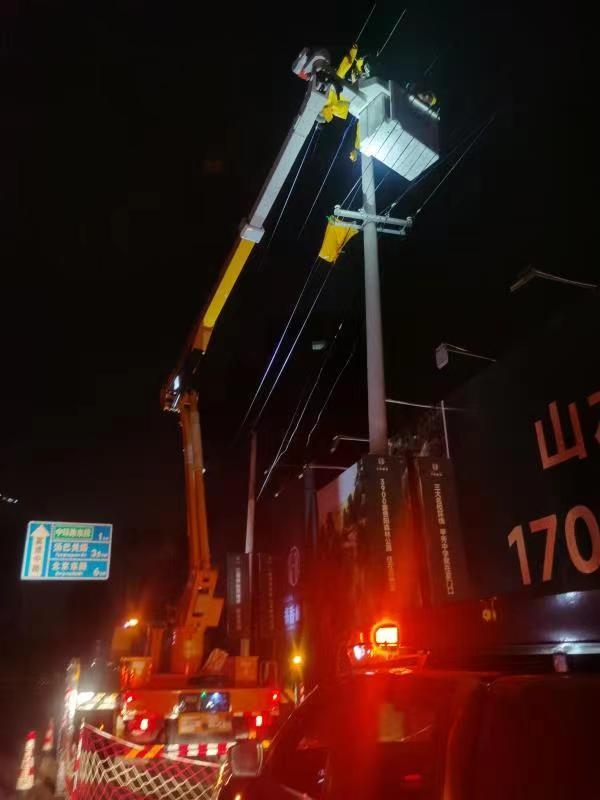 6月19日,受强降雨和大风影响,贵阳市南明区富源中路,大树倾倒压在10千伏二舒线上,致使高压线和电杆断裂。南方电网抢修人员迅速出动,彻夜苦战,并于20日凌晨完成抢修工作,10千伏二舒线全线送电成功。(刘微 谢忠华 摄).jpg