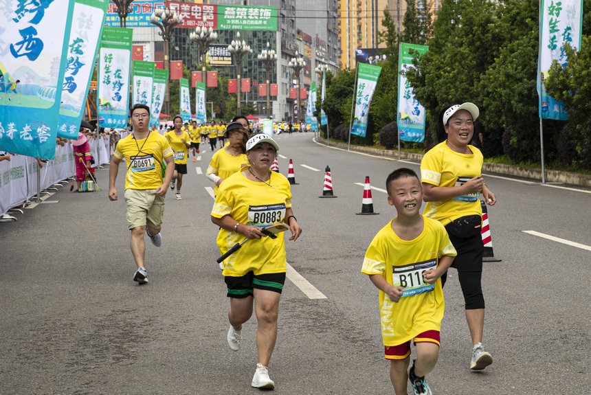 8月6日，2023中国全民健身走（跑）大赛（贵州 黔西站）比赛现场，参赛选手在走（跑）比赛过程中。