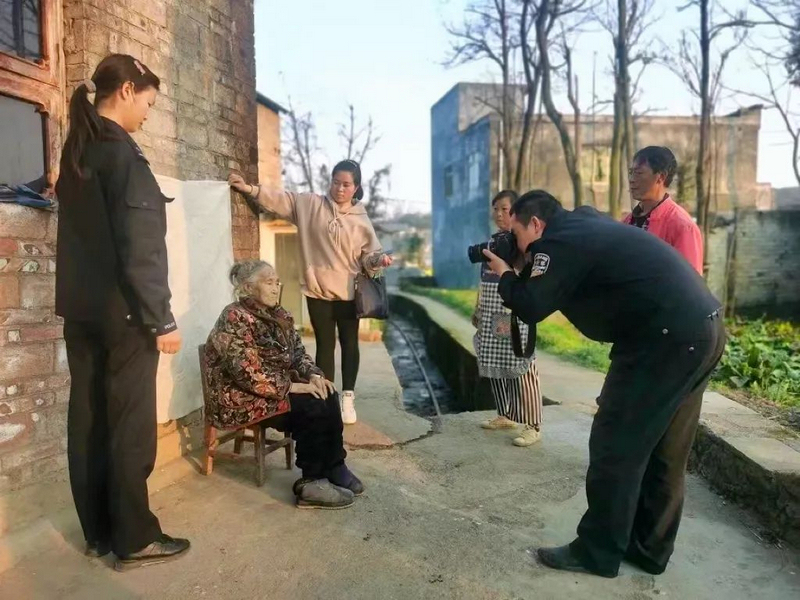 民警帮老人拍照 。北盘江中心派出所供图
