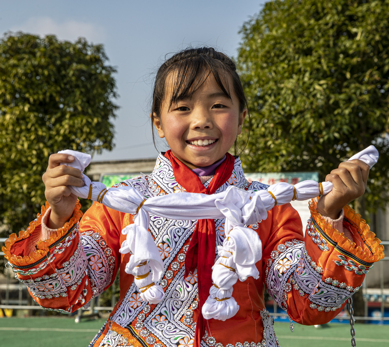 2023年12月28日，贵州省黔西市林泉镇高锦社区高锦小学，学生展示染色前已完成捆扎的白色布料。