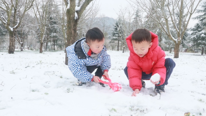 两个小朋友玩雪。 税会静摄