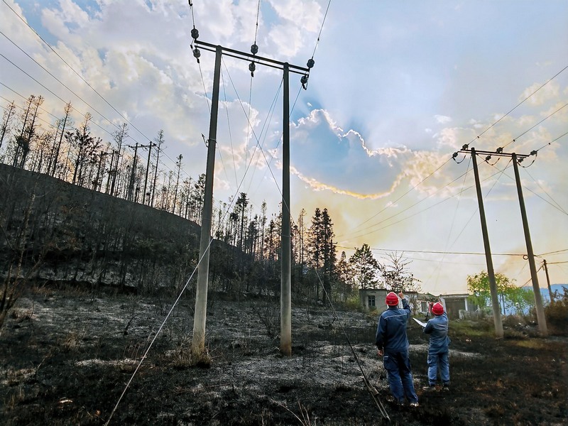 南方電網興仁供電局工作人員對受山火區域線路及電杆基角路面穩固情況進行排查。