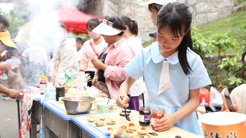 4月29日，同学们在美食节现场制作美食。周训贵摄