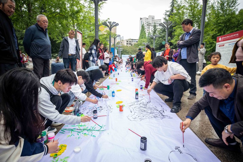 2024年5月11日，人们在贵州省毕节市人民公园里共同绘制“百米长卷节水图”。