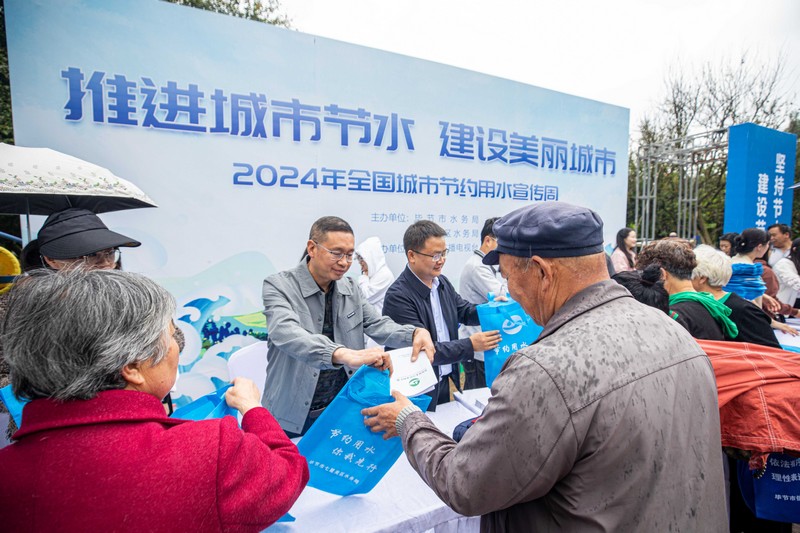 2024年5月11日，市民在贵州省毕节市人民公园里领取节水宣传小礼品。