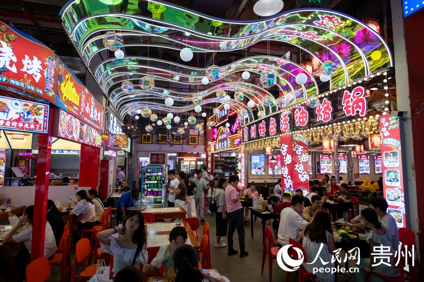 6月21日，在青云市集内，游客品尝各种美食。人民网记者 翁奇羽摄