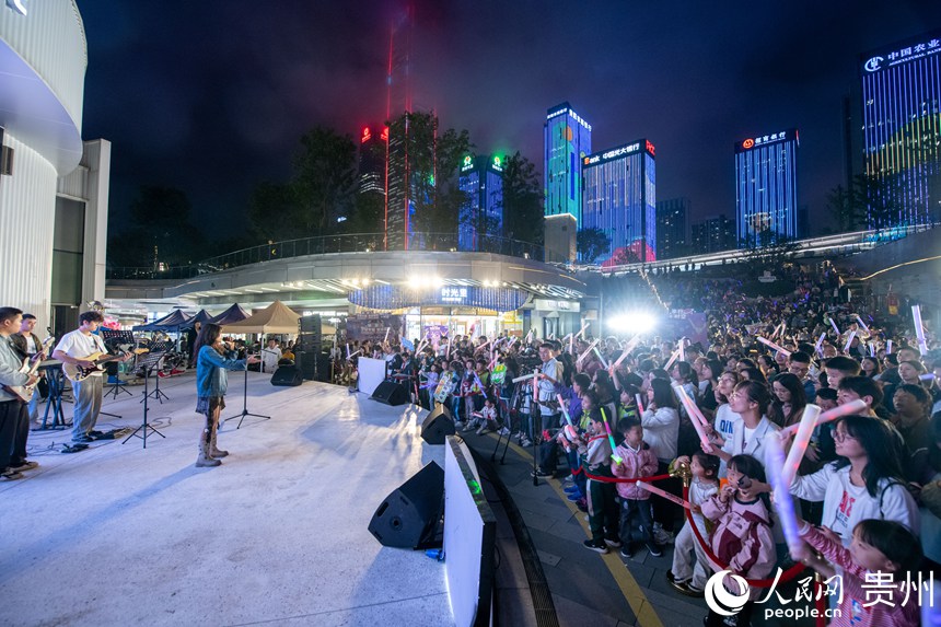 6月26日晚，贵阳市观山湖路边音乐会现场气氛热烈，观众陶醉音乐之中。 人民网记者 翁奇羽摄