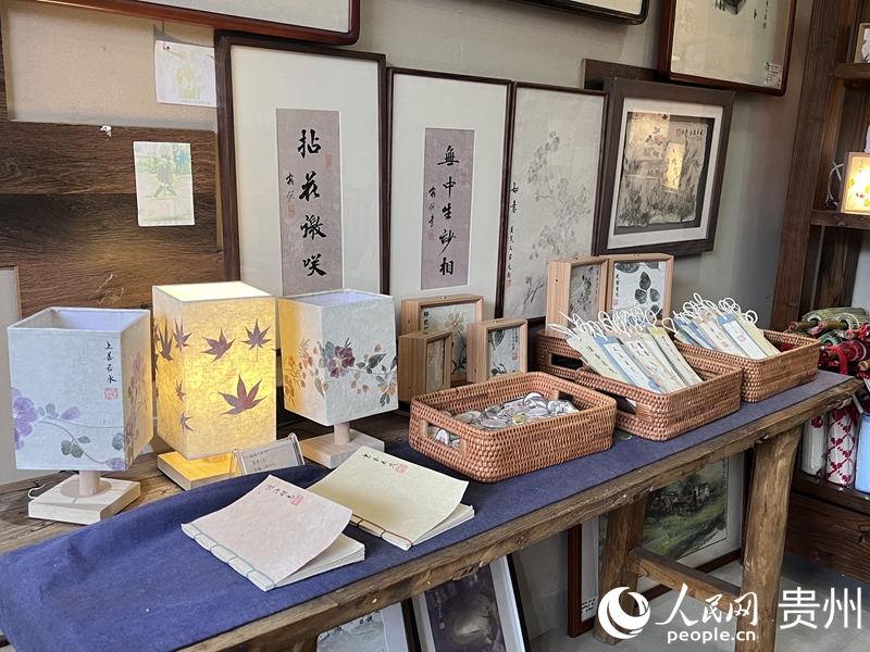 “花茂人家”作坊里，山水画、油纸伞、花草纸灯等手工艺品琳琅满目。人民网 陈洁泉摄