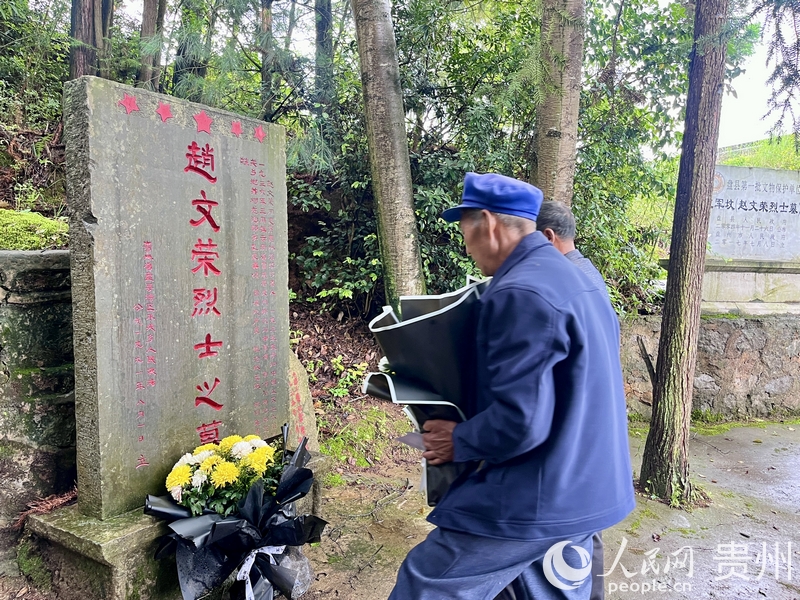 邹广阳、邹广周在赵文荣烈士墓前洒扫、献花。人民网 陈洁泉摄.jpg