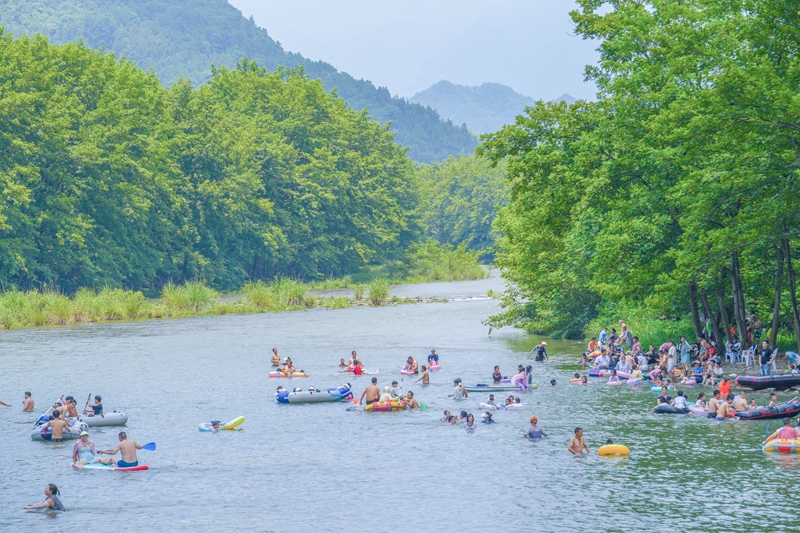 2025年7月19日，贵州省铜仁市江口县，市民们在梵净山山下太平河段戏水消暑，享受清凉。申逸恺摄