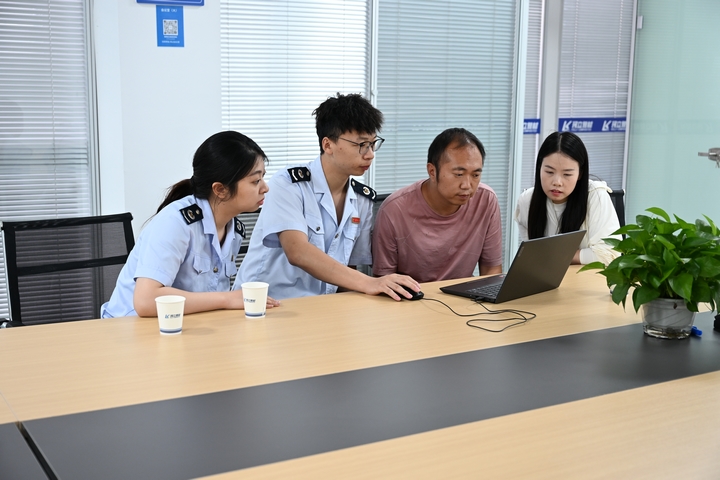 龙里税务干部辅导企业财务人员申报纳税。
