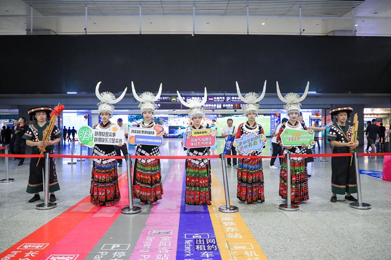 身着精美苗族服饰的姑娘们手举欢迎牌2