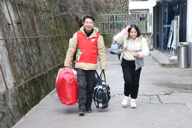 图为施秉县杨柳塘镇志愿者正在火车站给返乡的群众搬运行李。