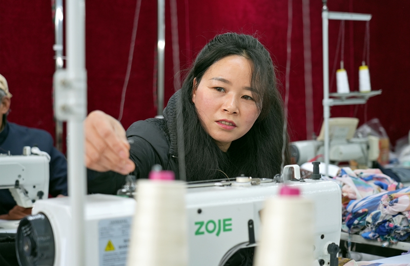 2026年1月12日，貴州省畢節市納雍縣化作鄉銀鑫制衣廠，工人在整理線。