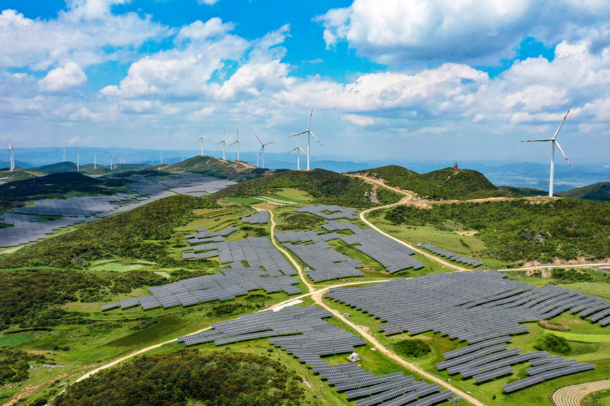 在威寧自治縣雙龍鎮涼山社區光伏發電站基地，藍天白雲、風力發電機、光伏板、種植的飼草交相輝映，勾勒出一幅美麗的生態畫卷。岳剛攝