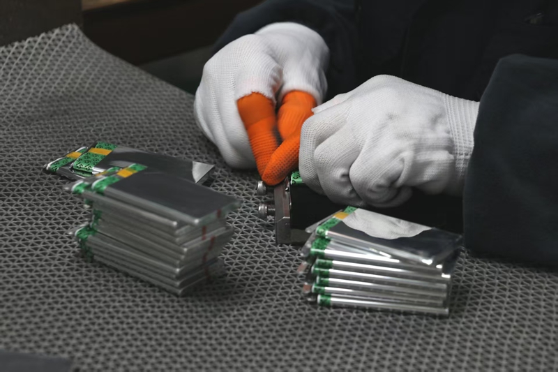 贵州贵航新能源科技有限公司生产车间,一台台锂离子电池智能生产设备高效运转,工人们有序开展配料、涂片、封装等工序。 邱雪 摄