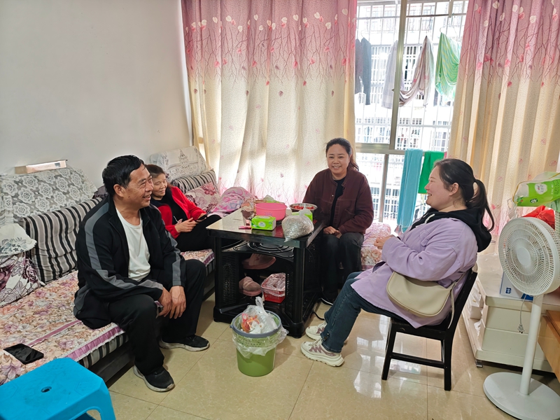 社区工作人员走访王军强家，左一为王军强。犹品娥 摄