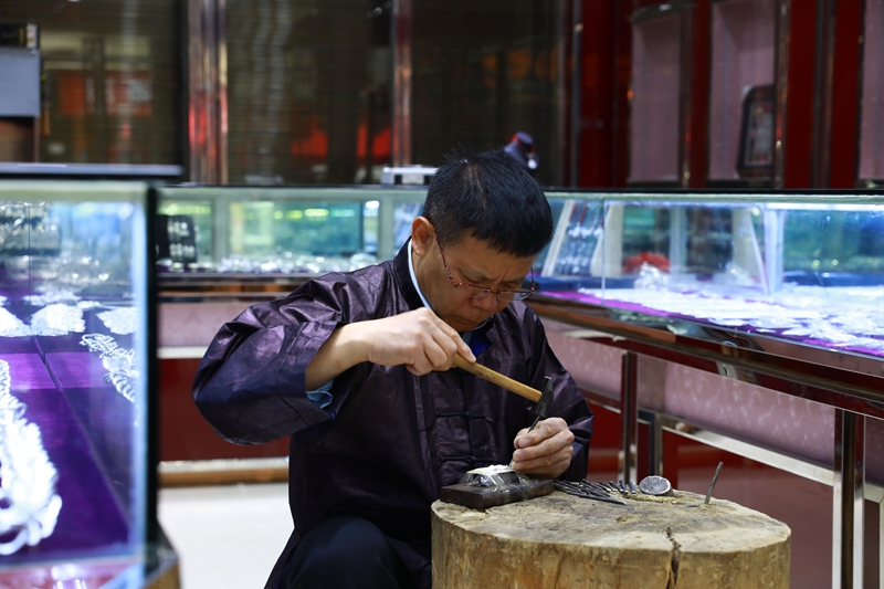 剑河县银匠邰引岩在制作银饰。