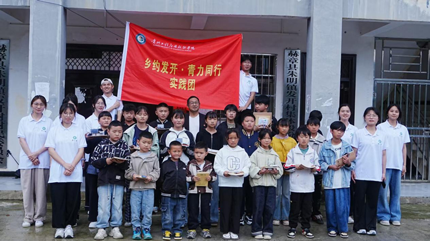 图为实践队队员与村支书及孩子们合照。