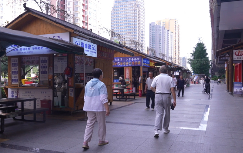 来盘州避暑的游客走进盘州街头。