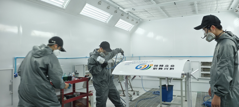 职校学生练习汽车喷绘。