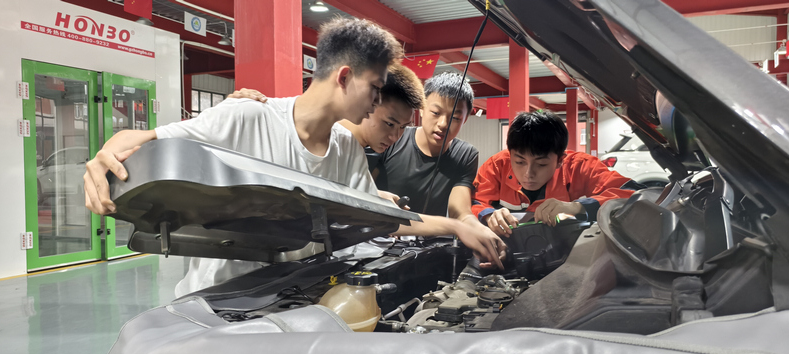 职校学生检查燃油汽车发动机舱。