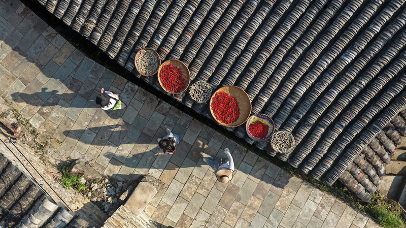 劍河縣革東鎮屯州村，村民在瓦屋上晾晒的農作物。吳麟欽攝